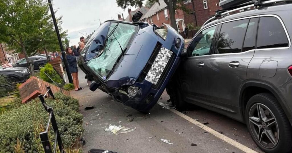 Car left smashed up and wedged on two wheels after crash on North East street
